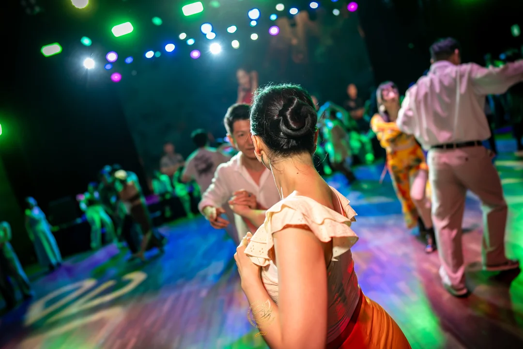 Participantes bailando juntos al ritmo de la música durante el evento social dominical de SIDF 2026